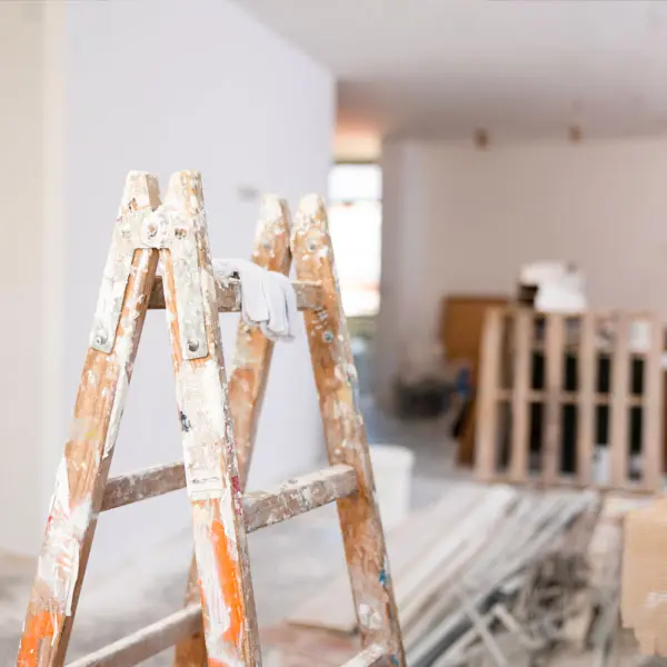 Interior of a UK property under refurbishment with a ladder, renovation in progress before sale.